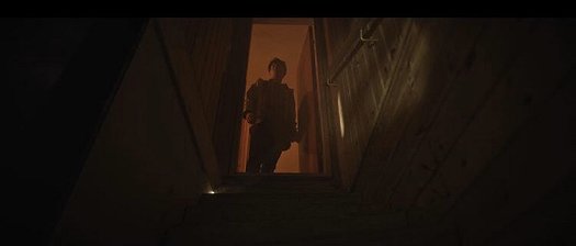 Still from the Colour of Madness - man in doorway