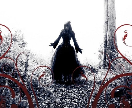 image of a witch in a long dress standing in forest