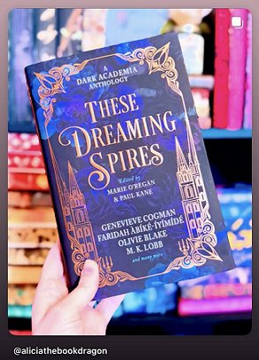 photograph of a hand holding a copy of These Dreaming Spires, edited by Marie O'Regan and Paul Kane, up against colourful bookshelves