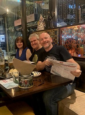 Photograph of Marie O'Regan, Paul Kane and Tim Lebbon in a restaurant at night