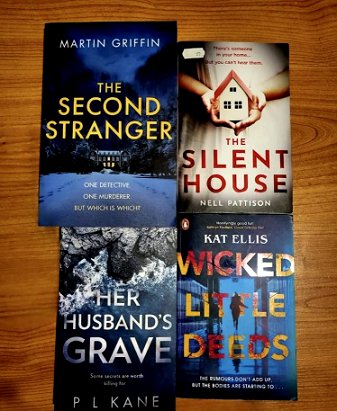 Book display featuring Her Husband's Grave by P L Kane