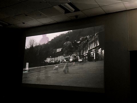 Still from Opportunity, short film from a story by Paul Kane - shows people walking up a hill