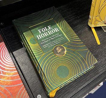 photograph showing a copy of Beyond & Within Folk Horror, edited by Paul Kane and Marie O'Regan, on a black shelf