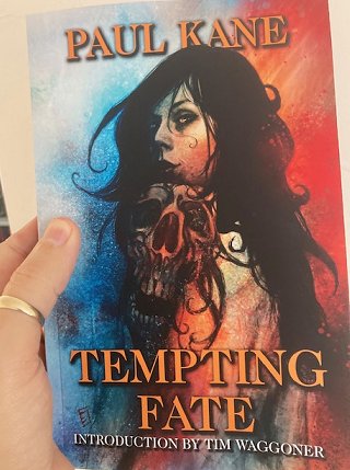 Paul Kane holding a copy of his book, Tempting Fate